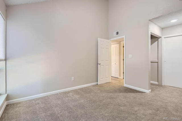 3539 S Fairplay Way Unit 10, Aurora, CO 80014 - unfurnished bedroom featuring carpet, baseboards, and a high ceiling