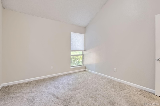 3539 S Fairplay Way Unit 10, Aurora, CO 80014 - spare room with vaulted ceiling, baseboards, and carpet