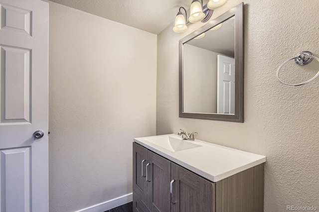 3539 S Fairplay Way Unit 10, Aurora, CO 80014 - bathroom featuring vanity and a textured wall