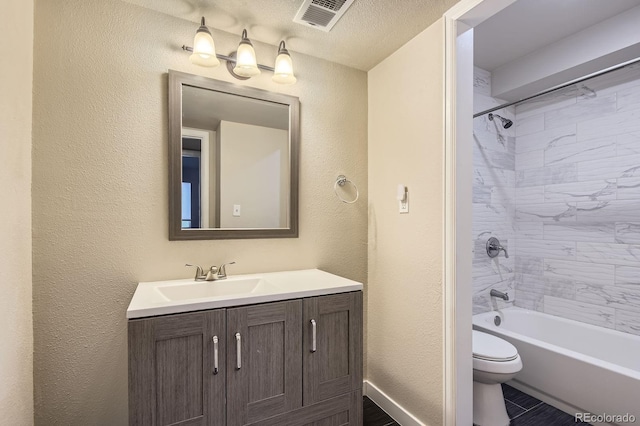 3539 S Fairplay Way Unit 10, Aurora, CO 80014 - bathroom featuring vanity, a textured wall, toilet, and bathing tub / shower combination