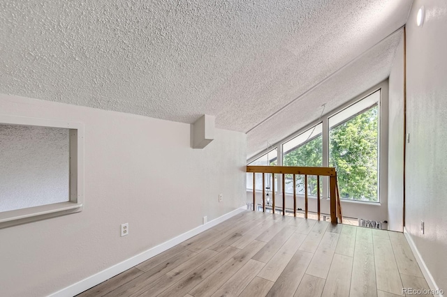 3539 S Fairplay Way Unit 10, Aurora, CO 80014 - empty room with a textured ceiling, baseboards, and wood finished floors