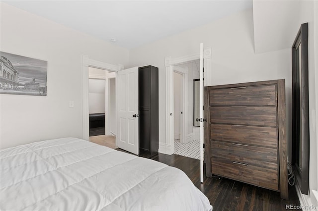 bedroom with dark hardwood / wood-style floors