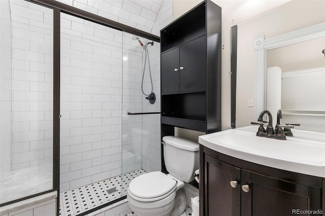 bathroom with vanity, toilet, and an enclosed shower