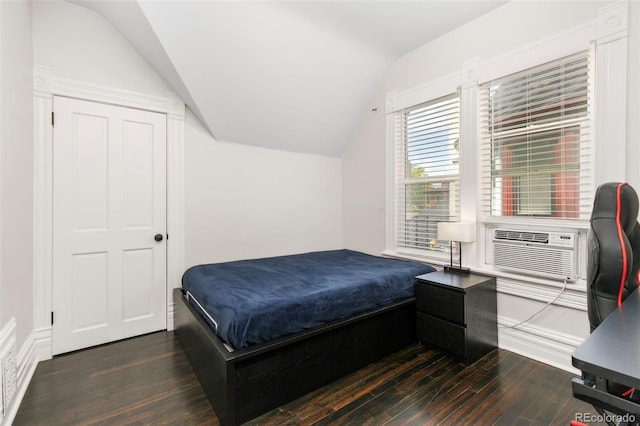 bedroom with dark hardwood / wood-style flooring, cooling unit, and vaulted ceiling