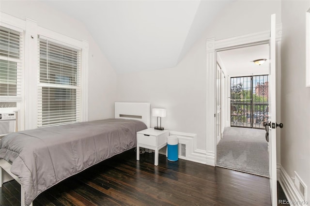 bedroom featuring lofted ceiling and dark wood-type flooring