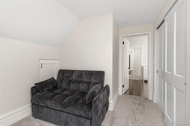 living area with carpet flooring and lofted ceiling