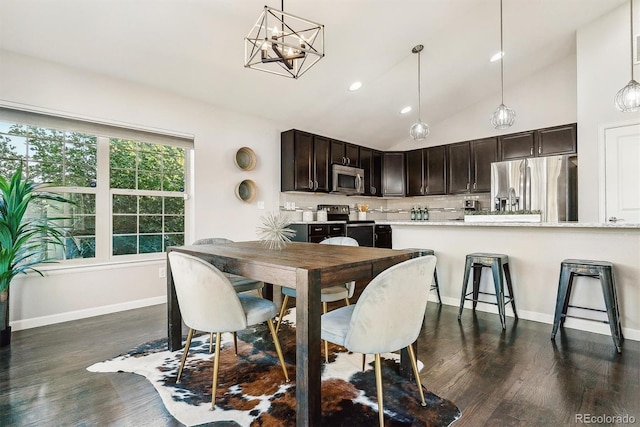 dining area featuring an inviting chandelier, baseboards, high vaulted ceiling, and dark wood-style flooring