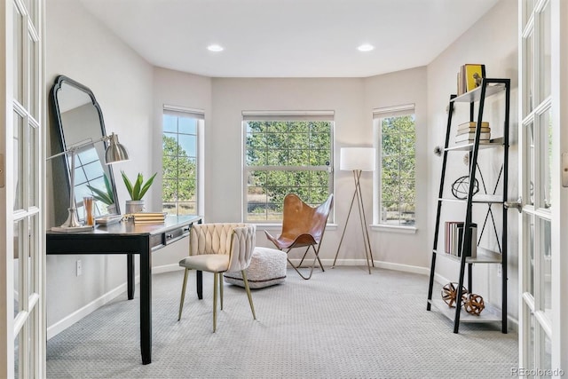 living area featuring recessed lighting, light colored carpet, a wealth of natural light, and baseboards