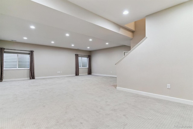 interior space featuring baseboards, light colored carpet, and recessed lighting