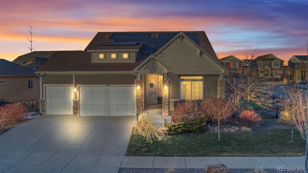 view of front of home with a garage and solar panels