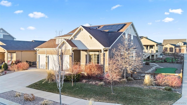 view of front of property featuring solar panels and a front yard