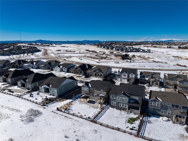 snowy aerial view featuring a mountain view