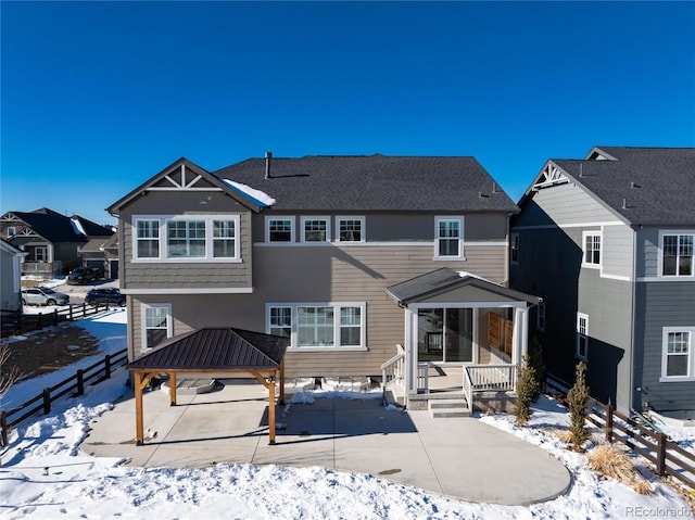 snow covered property with a gazebo