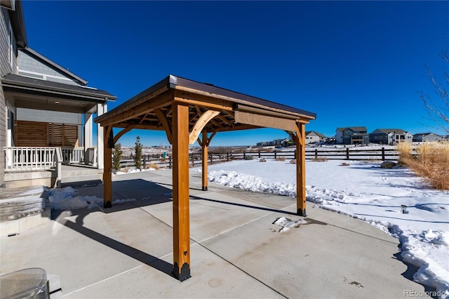 snow covered patio featuring a gazebo