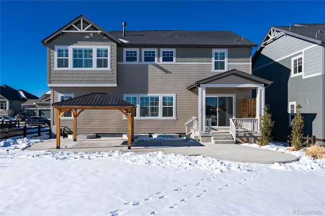 snow covered property with a gazebo