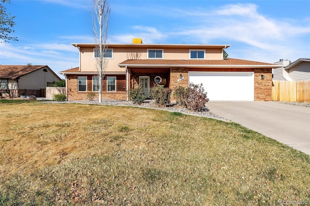 3730 Applewood St, Grand Junction, CO 81506 - traditional-style house with a front yard, a garage, fence, concrete driveway, and brick siding