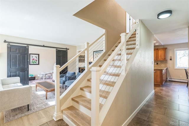 3730 Applewood St, Grand Junction, CO 81506 - stairway featuring a barn door, a baseboard heating unit, and baseboards