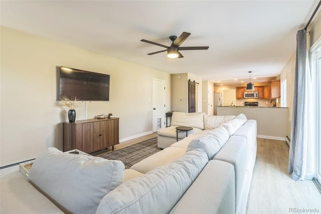 3730 Applewood St, Grand Junction, CO 81506 - living room with light wood-style flooring, baseboards, and a ceiling fan