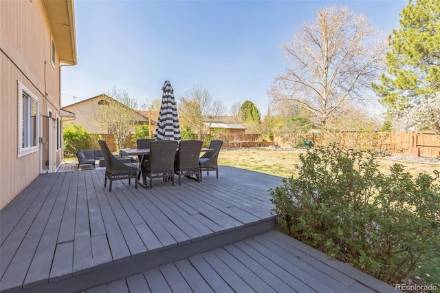 3730 Applewood St, Grand Junction, CO 81506 - deck featuring a fenced backyard, outdoor dining area, and a lawn