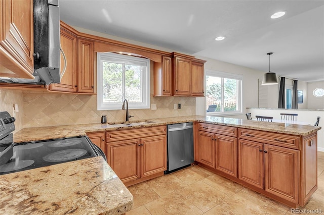 3730 Applewood St, Grand Junction, CO 81506 - kitchen featuring brown cabinetry, a peninsula, appliances with stainless steel finishes, a sink, and decorative backsplash