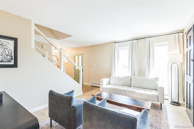 3730 Applewood St, Grand Junction, CO 81506 - living area featuring a baseboard radiator, a healthy amount of sunlight, light wood finished floors, and stairs