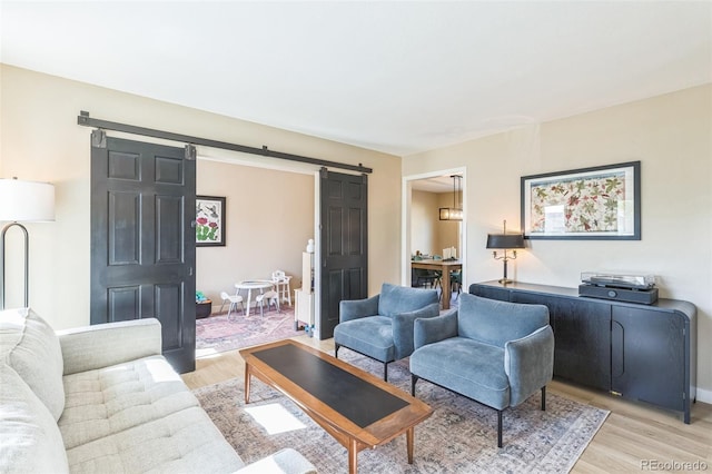3730 Applewood St, Grand Junction, CO 81506 - living area featuring a barn door, baseboards, and light wood finished floors
