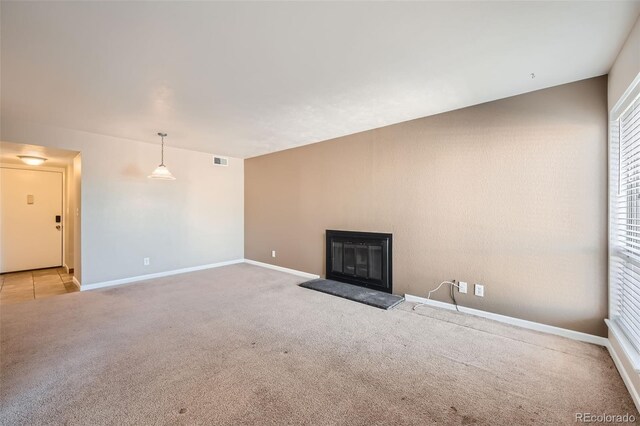 unfurnished living room with light carpet