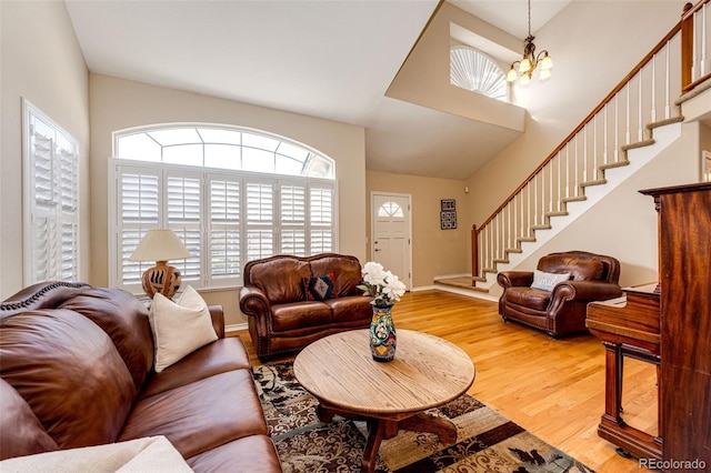 6454 S Nelson Way, Littleton, CO 80127 - living area with stairs, wood finished floors, a chandelier, lofted ceiling, and baseboards