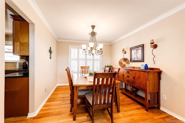 6454 S Nelson Way, Littleton, CO 80127 - dining room with a chandelier, light wood-style floors, crown molding, and baseboards