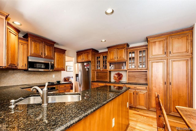 6454 S Nelson Way, Littleton, CO 80127 - kitchen featuring stainless steel appliances, a sink, recessed lighting, brown cabinetry, and decorative backsplash