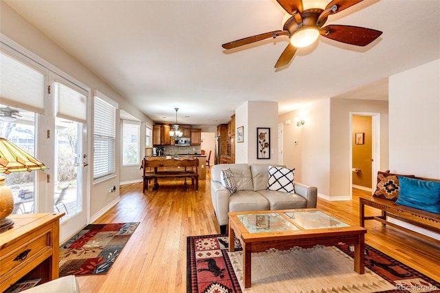 6454 S Nelson Way, Littleton, CO 80127 - living area featuring light wood-type flooring, baseboards, and ceiling fan