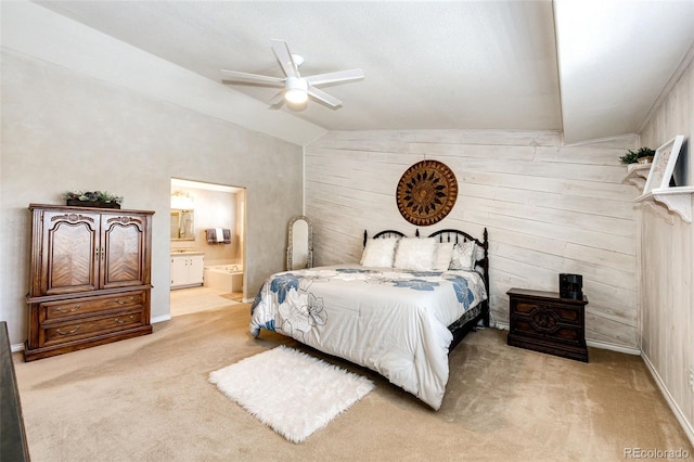 6454 S Nelson Way, Littleton, CO 80127 - carpeted bedroom featuring lofted ceiling, ensuite bath, wood walls, baseboards, and ceiling fan