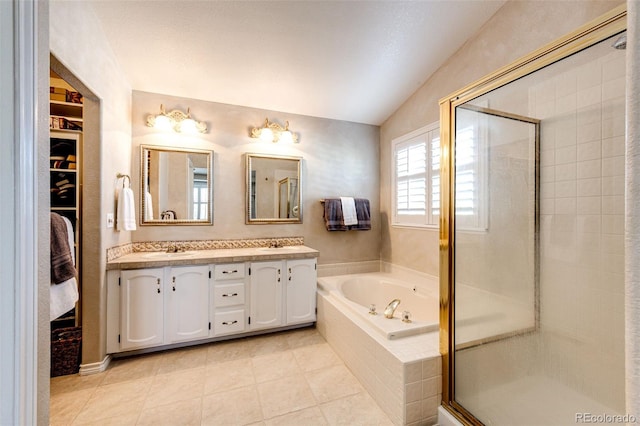 6454 S Nelson Way, Littleton, CO 80127 - full bathroom with a stall shower, double vanity, a garden tub, vaulted ceiling, and tile patterned floors