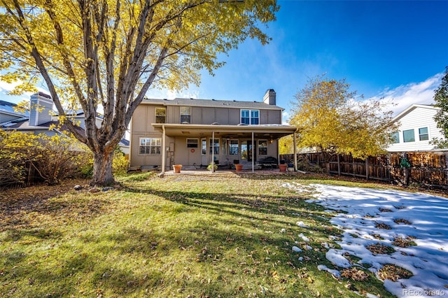 6454 S Nelson Way, Littleton, CO 80127 - back of property featuring a chimney and a patio area