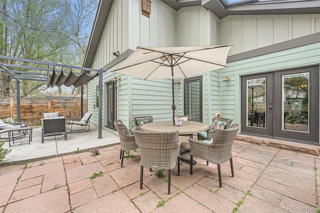 view of patio / terrace featuring french doors, fence, a pergola, and outdoor dining area