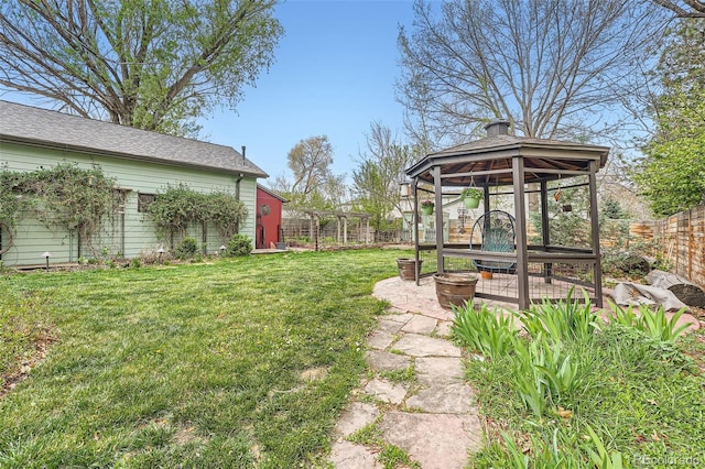 view of yard with a gazebo, fence, and a fire pit
