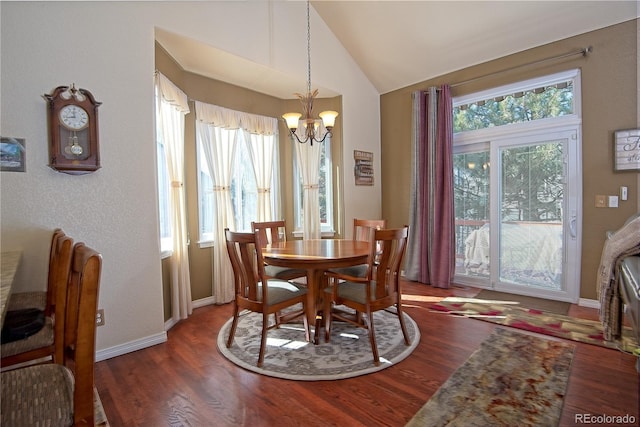 dining space with lofted ceiling, dark hardwood / wood-style floors, and a notable chandelier