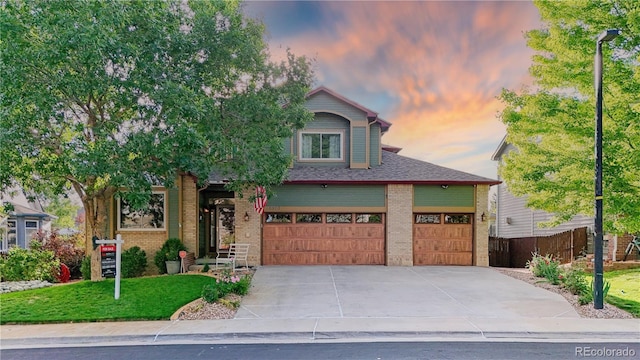 16873 Boreas Ct, Parker, CO 80134 - view of front of house with concrete driveway, brick siding, a lawn, and an attached garage
