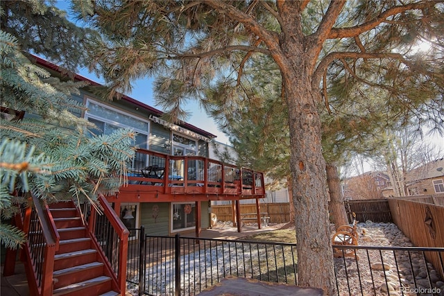 16873 Boreas Ct, Parker, CO 80134 - back of house with stairs, a wooden deck, a fenced backyard, and a patio