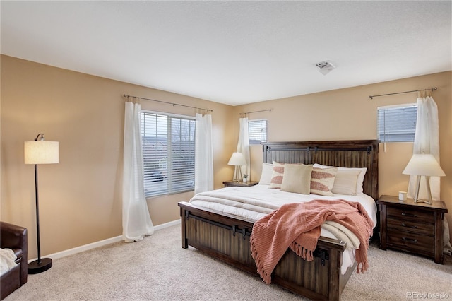 carpeted bedroom with visible vents and baseboards
