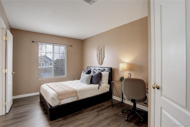 bedroom featuring dark wood-type flooring and baseboards