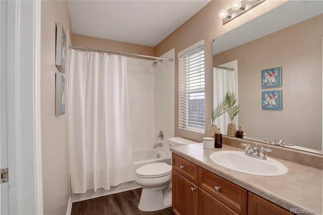 full bathroom with toilet, shower / bathtub combination with curtain, vanity, and wood finished floors
