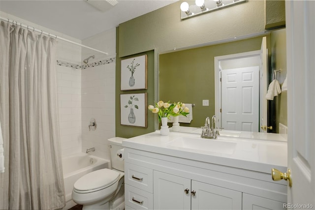 full bathroom with toilet, shower / bath combo, vanity, and a textured wall