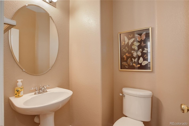 bathroom with toilet and a sink