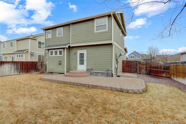 rear view of house featuring a yard, a patio, and a fenced backyard