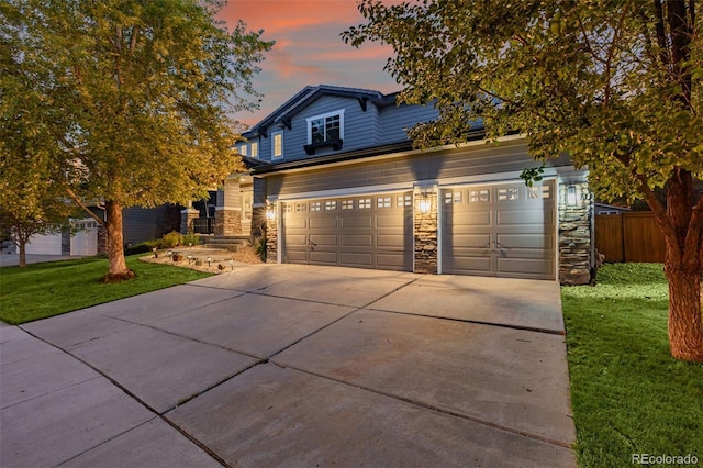 view of front of property with a yard and a garage