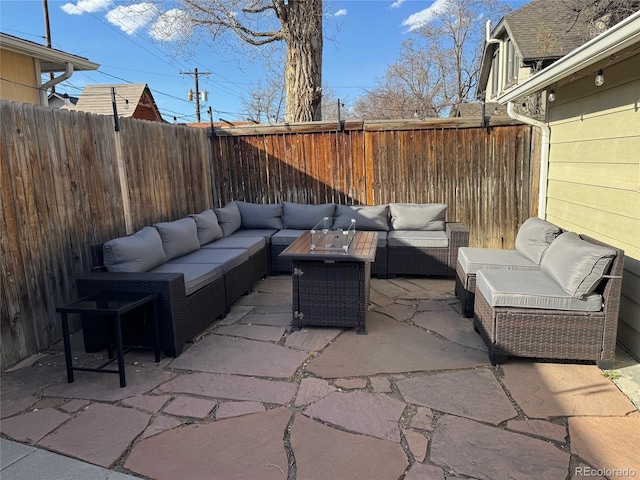 view of patio with an outdoor living space and a fenced backyard