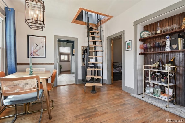 dining area featuring hardwood / wood-style flooring and a notable chandelier