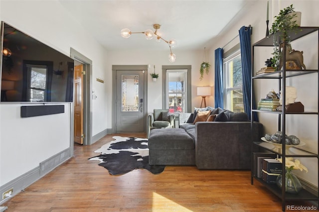 living area featuring baseboards and wood finished floors