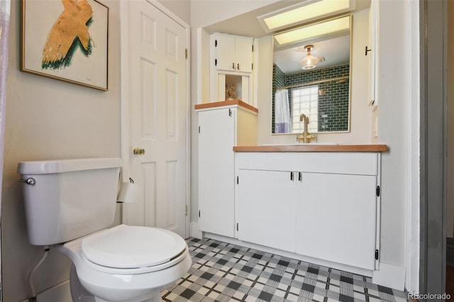 bathroom featuring toilet and vanity